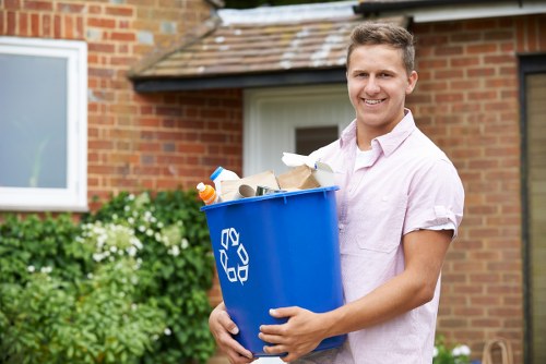 Family unloading household waste into a domestic skip